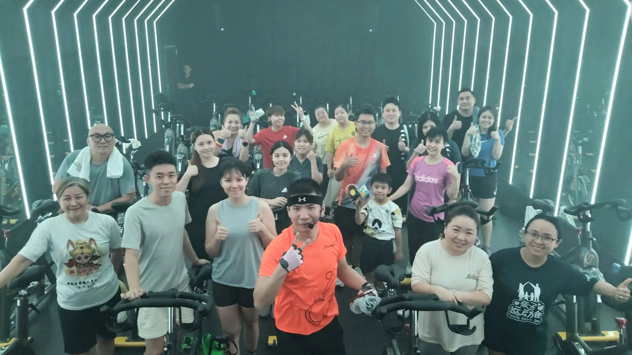 The studio's nested chevron light rig above a full class, coach at the front
