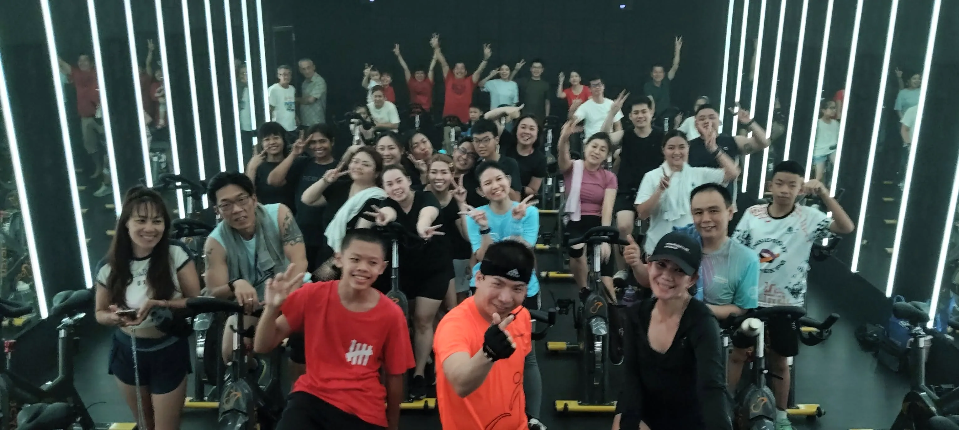 A packed J Cycle class, light bars running down both walls